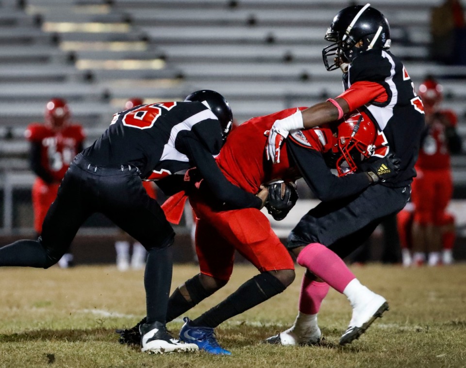 <strong>Middle College's Michael Mason (left) and Kylan Bowers (right) bring down Westwood's Amarion Marshall on a kickoff return Oct. 31.</strong> (Mark Weber/Daily Memphian)