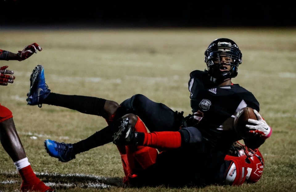 <strong>Middle College quarterback Benjamin Calvin (top) is tackled by Westwood defender Amarion Marshall (bottom) Oct. 31.</strong> (Mark Weber/Daily Memphian)