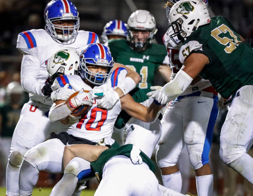 <strong>MUS running back Hunter Kendall (with ball) is tackled by Briarcrest Nov. 1.</strong> (Mark Weber/Daily Memphian)