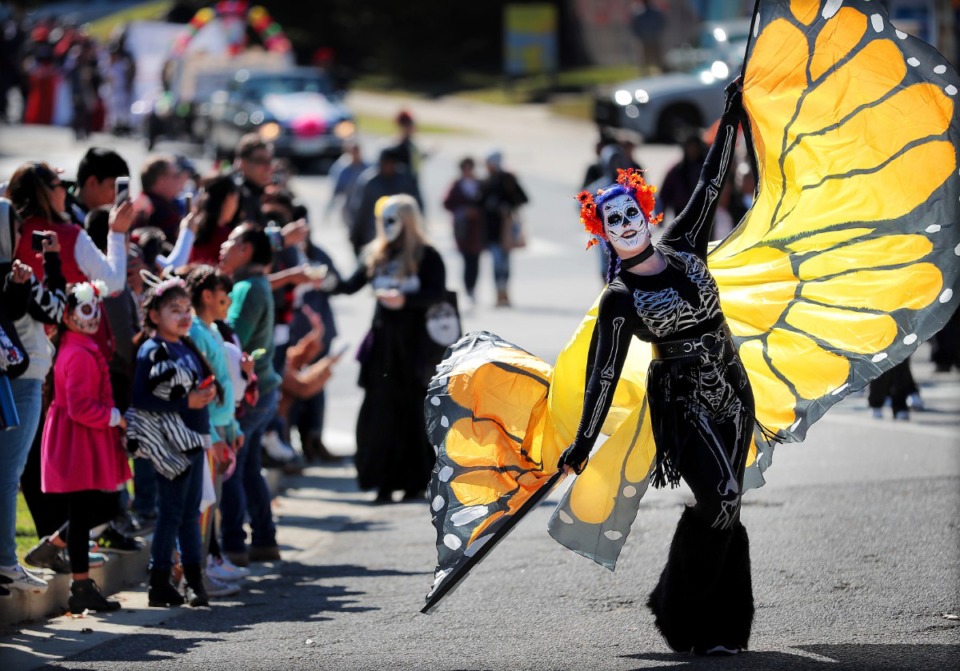 <strong>Jessy Meadows accompanies the Memphis Record Presses float during the Dia de los Muertos (Day of the Dead) parade from Overton Square to Overton Park on Nov. 2, 2018. The parade and festival are put on by the Brooks Museum of Art and Cazateatro Bilingual Theatre Group drawing from the Latin American tradition of honoring ancestors and celebrating the cycle of life and death.</strong> (Jim Weber/Daily Memphian)