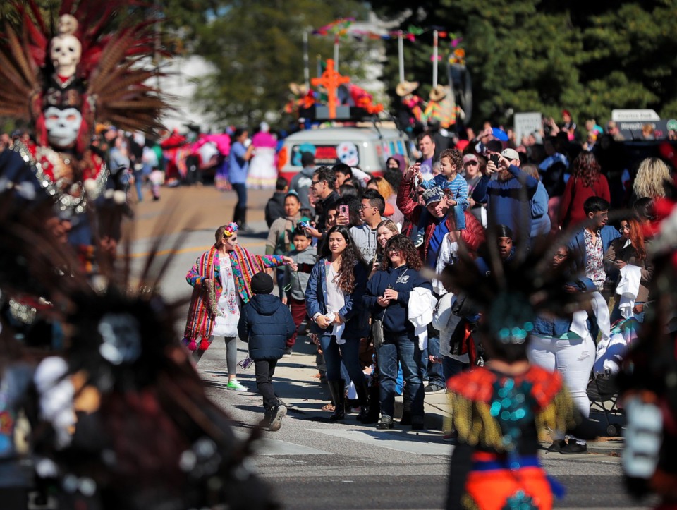 <strong>Paradegoers line up along the entrance to Overton Park to watch the incoming parade during the Dia de los Muertos (Day of the Dead) celebration on Nov. 2, 2018. The parade and festival are put on by the Brooks Museum of Art and Cazateatro Bilingual Theatre Group drawing from the Latin American tradition of honoring ancestors and celebrating the cycle of life and death.</strong> (Jim Weber/Daily Memphian)