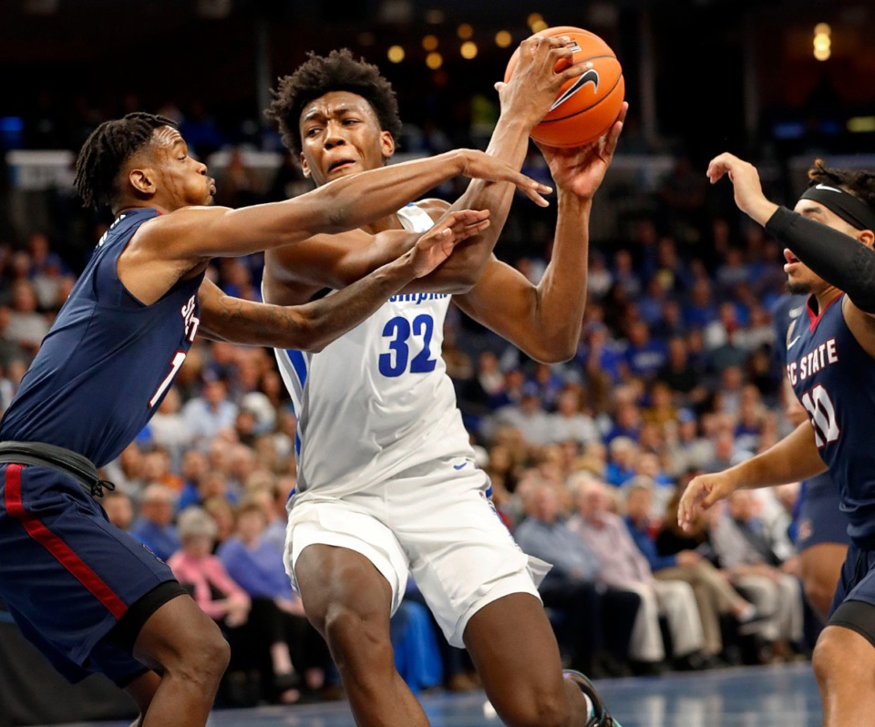 <strong>Memphis center James Wiseman (right) drives the lane against South Carolina State's Tariq Simmons (left) Nov. 5 at FedExForum.</strong> (Mark Weber/Daily Memphian)