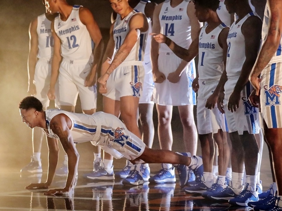 <strong>Boogie Ellis does a few push ups to get pumped up during a photo session with the University of Memphis basketball team on Oct. 11.</strong> (Jim Weber/Daily Memphian)
