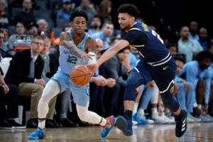 <strong>Memphis Grizzlies guard Ja Morant (12) and Denver Nuggets guard Jamal Murray struggle for control of the ball in the first half of an NBA basketball game Sunday at FedExForum.</strong> (Brandon Dill/AP)