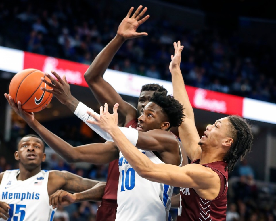 <strong>Memphis guard Damion Baugh (middle) is fouled while driving to the basket against Little Rock defender Isaiah Palermo (right) Nov. 20 at FedExForum.</strong> (Mark Weber/Daily Memphian)
