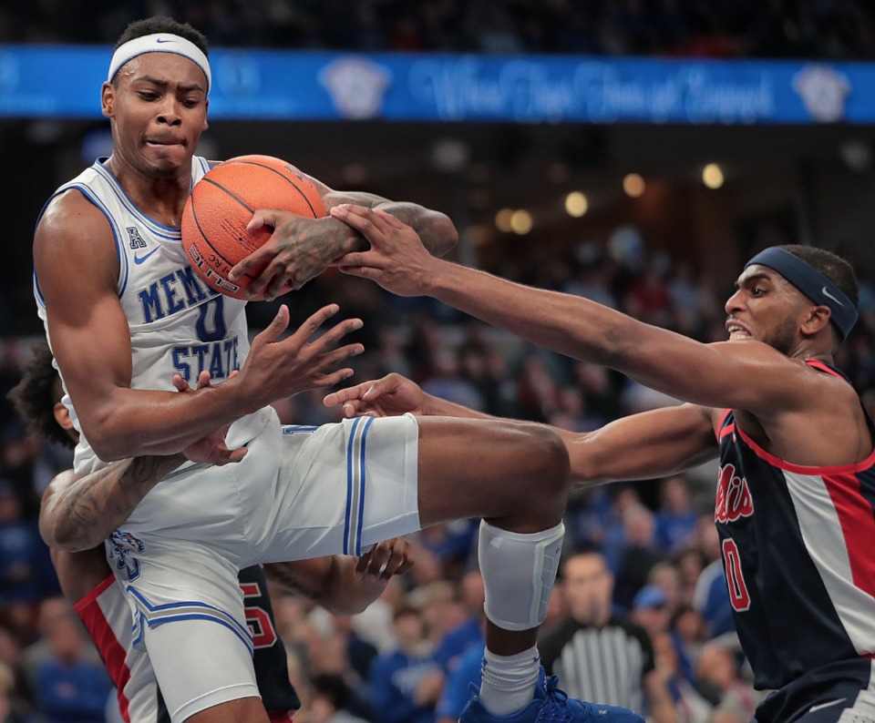 <strong>University of Memphis forward DJ Jeffries (0) scrambles for a rebound under pressure by Ole Miss Blake Hinson (right) during the Tigers game on Nov. 23, 2019, against the University of Mississippi at FedExForum.</strong> (Jim Weber/Daily Memphian)