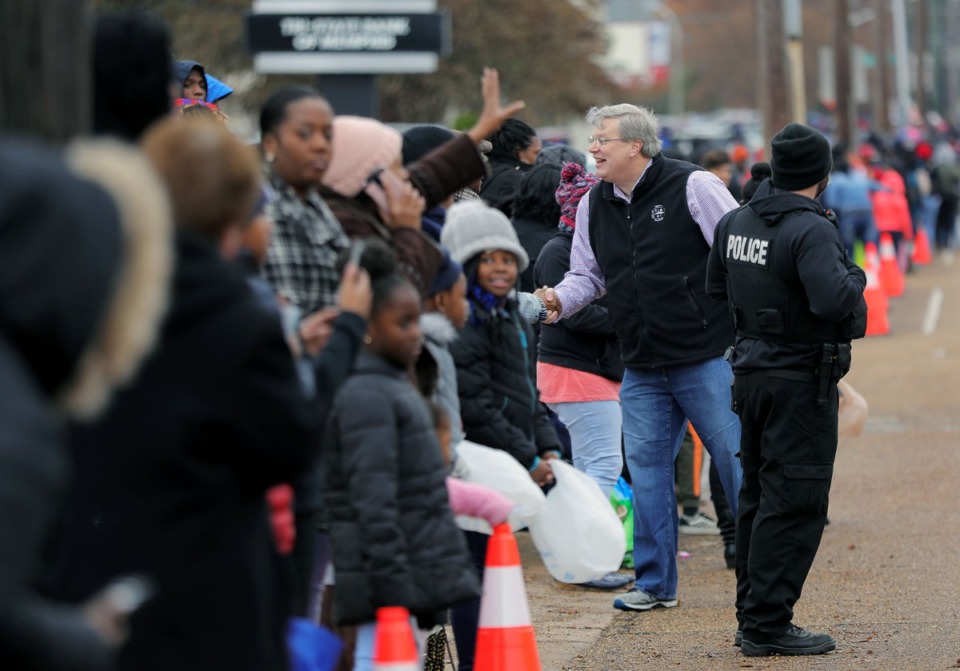 <strong>Memphis Mayor Jim Strickland shakes hands with parade goers along Elvis Presley Boulevard during the Memphis Christmas Parade in Whitehaven.</strong> (Patrick Lantrip/Daily Memphian)