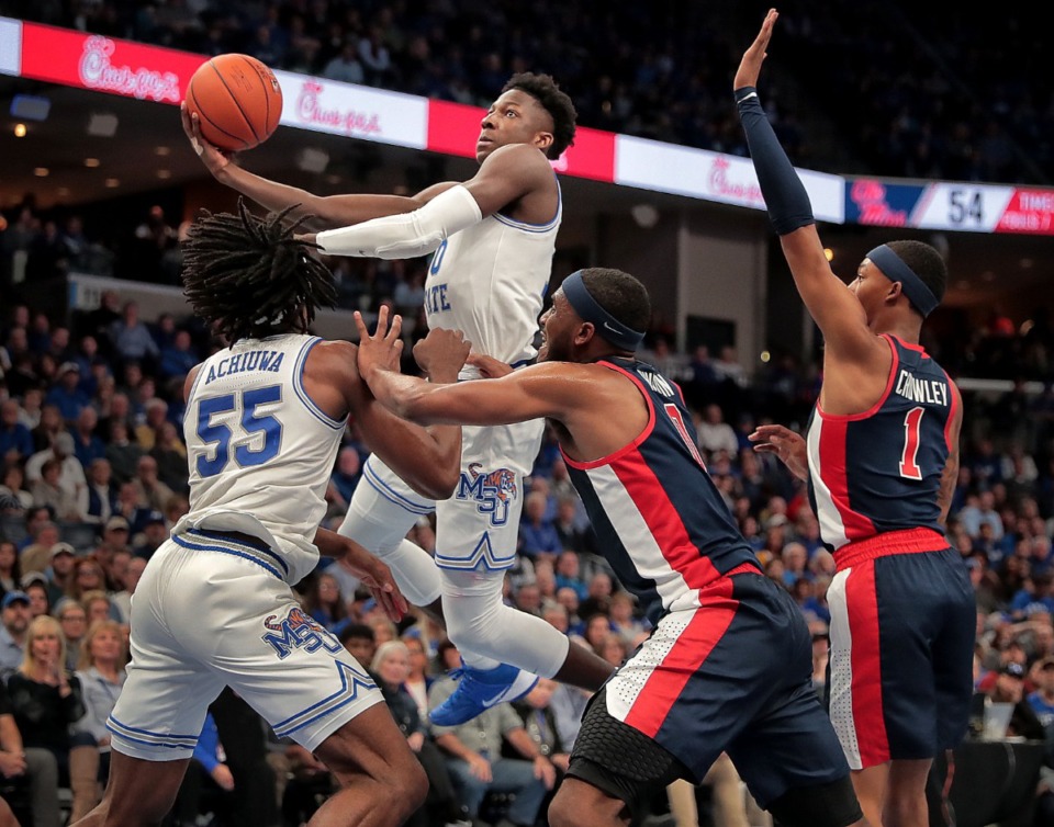 <strong>University of Memphis guard Damion Baugh (10) shoots under pressure by Ole Miss during the Tigers' game on Nov. 23, 2019, against Mississippi at FedExForum.</strong> (Jim Weber/Daily Memphian)