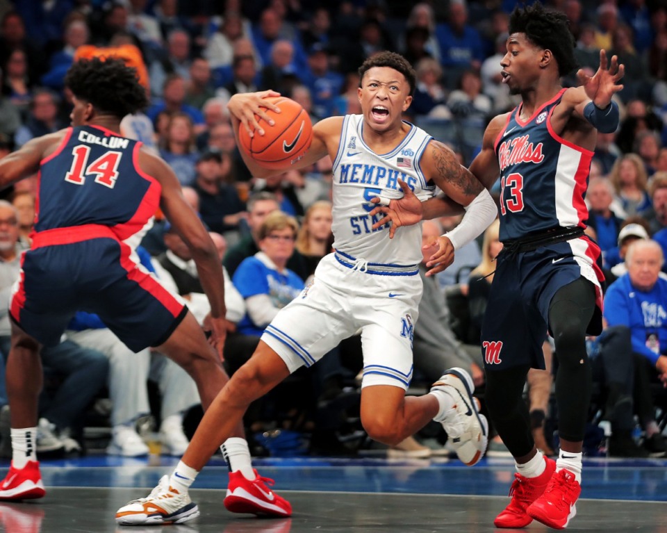 <strong>University of Memphis guard Boogie Ellis (5) charges past Ole Miss guard Bryce Williams (13) during the Tigers' game on Nov. 23, 2019, against Mississippi at FedExForum.</strong> (Jim Weber/Daily Memphian)