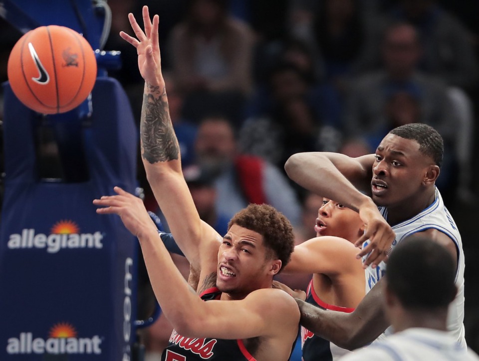 <strong>University of Memphis forward Lance Thomas (right) knocks a rebound away from Ole forward Miss KJ Buffen (left) during the Tigers' game on Nov. 23, 2019, against Mississippi at FedExForum.</strong> (Jim Weber/Daily Memphian)