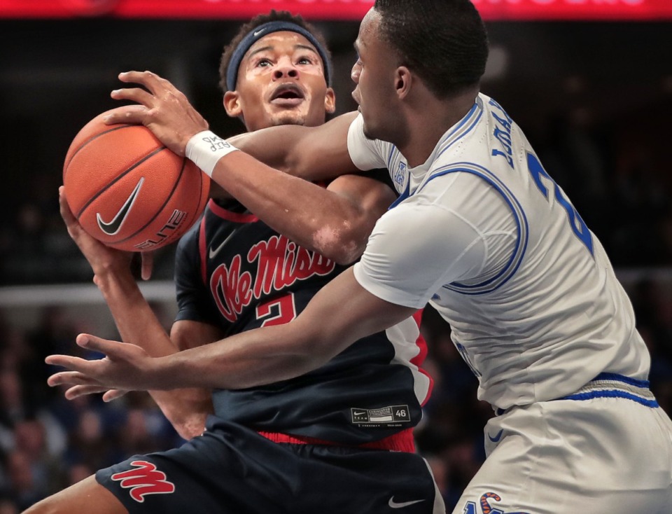 <strong>University of Memphis guard Alex Lomax (2) fouls Ole Miss guard Devontae Shuler during the Tigers' game on Nov. 23, 2019, against Mississippi at FedExForum.</strong> (Jim Weber/Daily Memphian)