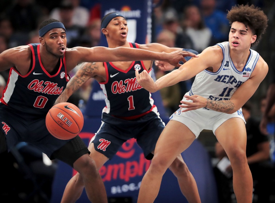 <strong>University of Memphis guard Lester Quinones (11) passes under pressure by Ole Miss guard Austin Crowley (1) and Blake Hinson (0) during the Tigers' game on Nov. 23, 2019, against Mississippi at FedExForum.</strong> (Jim Weber/Daily Memphian)