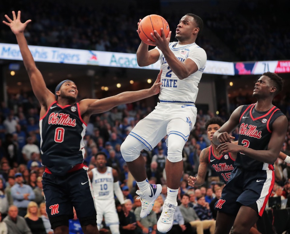 <strong>University of Memphis guard Alex Lomax (2) shoots under pressure by Ole Miss guard Blake Hinson (0) during the Tigers' game on Nov. 23, 2019, against Mississippi at FedExForum.</strong> (Jim Weber/Daily Memphian)