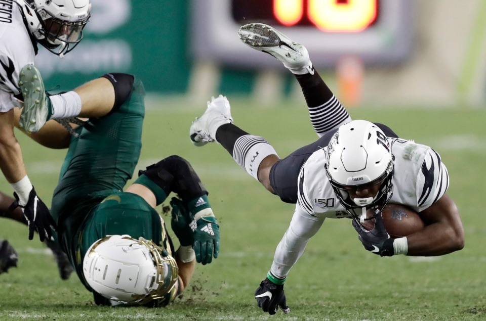 <strong>Memphis running back Kenneth Gainwell (19) gets upended by South Florida linebacker Andrew Mims during the second half of an NCAA college football game Saturday, Nov. 23, 2019, in Tampa, Fla.</strong> (AP Photo/Chris O'Meara)