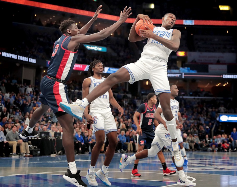 <strong>University of Memphis forward Lance Thomas (right) pulls down a rebound under pressure by Ole Miss forward Khadim Sy (3) during the Tigers' game on Nov. 23, 2019, against Mississippi at FedExForum.</strong> (Jim Weber/Daily Memphian)