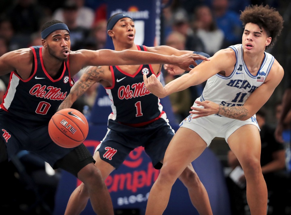 <strong>University of Memphis guard Lester Quinones (11) passes under pressure by Ole Miss guard Austin Crowley (1) and Blake Hinson (0) during the Tigers' game on Nov. 23, 2019.</strong>&nbsp;(Jim Weber/Daily Memphian)