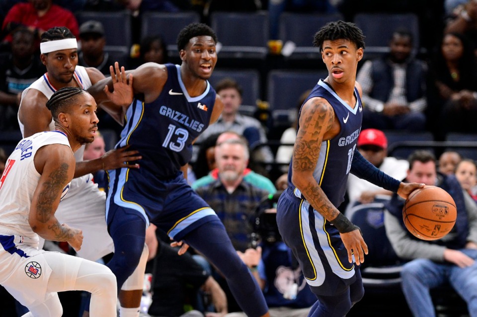 <strong>Memphis Grizzlies guard Ja Morant, right, handles the ball as Los Angeles Clippers guard Rodney McGruder, front left, and forward Maurice Harkless defend, while Grizzlies forward Jaren Jackson Jr. (13) assists Nov. 27 at FedExForum.</strong> (Brandon Dill/AP)
