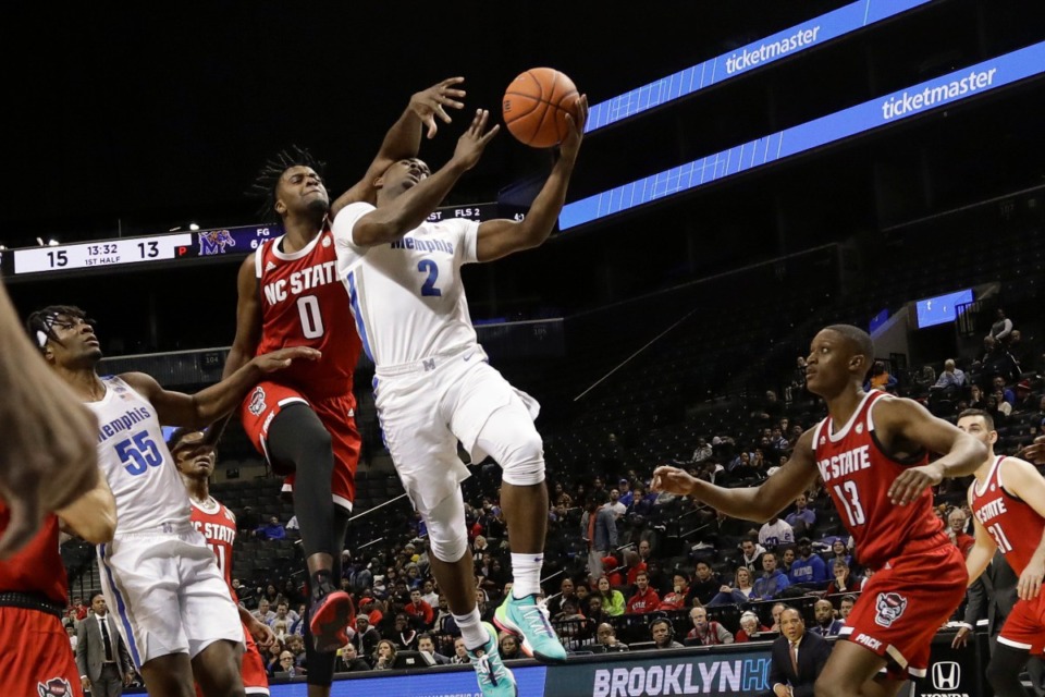 <strong>Memphis' Alex Lomax (2) drives past North Carolina State's DJ Funderburk (0) and C.J. Bryce (13) during the first half of a game in the Barclays Classic, Thursday, Nov. 28, 2019, in New York.</strong> (AP Photo/Frank Franklin II)