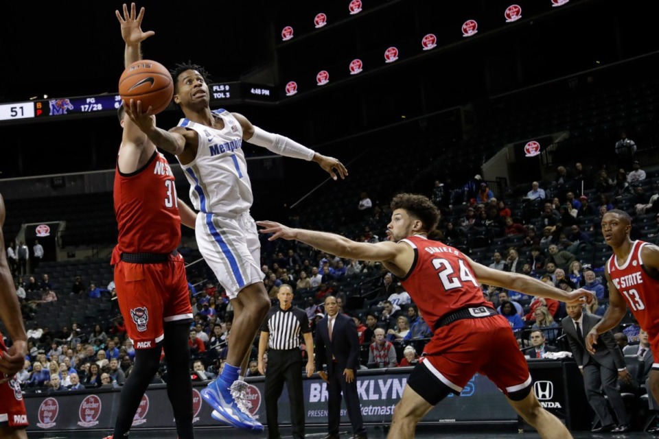 <strong>Memphis' Tyler Harris (1) drives past North Carolina State's Pat Andree (31) and Devon Daniels (24) during the first half of a game in the Barclays Classic Thursday, Nov. 28, 2019, in New York.</strong> (AP Photo/Frank Franklin II)