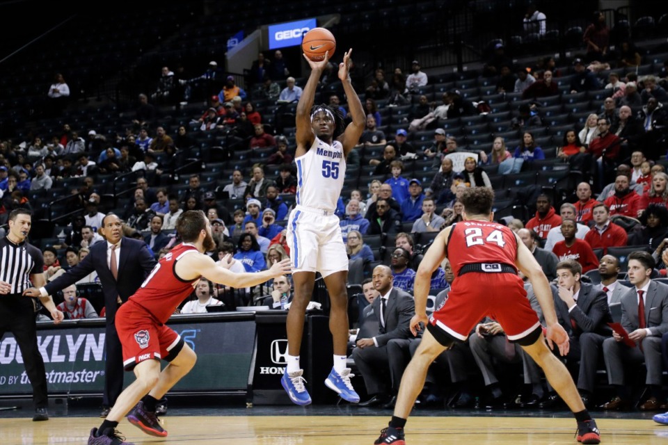 <strong>Memphis' Precious Achiuwa, center, shoots a three-point basket over North Carolina State's Braxton Beverly, left, and Devon Daniels during the first half of a game in the Barclays Classic, Thursday, Nov. 28, 2019, in New York.</strong> (AP Photo/Frank Franklin II)
