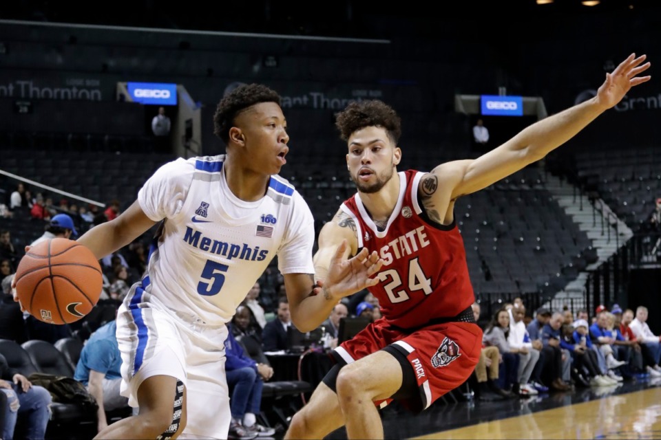 <strong>Memphis' Boogie Ellis (5) drives past North Carolina State's Devon Daniels (24) during the first half of a game in the Barclays Classic, Thursday, Nov. 28, 2019, in New York.</strong> (AP Photo/Frank Franklin II)