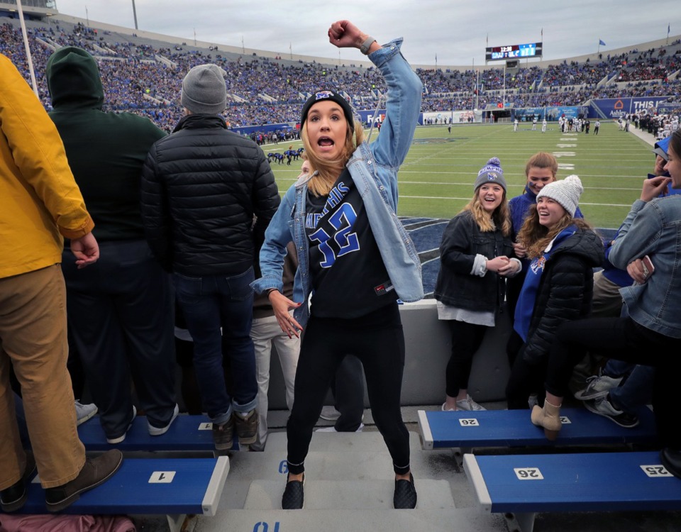<strong>A Tigers fan goes through the University of Memphis pom squad's routine move by move during the first half of the Nov. 29 home game against the University of Cincinnati.</strong> (Patrick Lantrip/Daily Memphian)