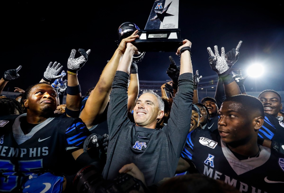 <strong>Memphis head coach Mike Norvell (middle) raises the AAC Western Divisional Champion Trophy after defeating Cincinnati Nov. 29 at Liberty Bowl Memorial Stadium.</strong> (Mark Weber/Daily Memphian)