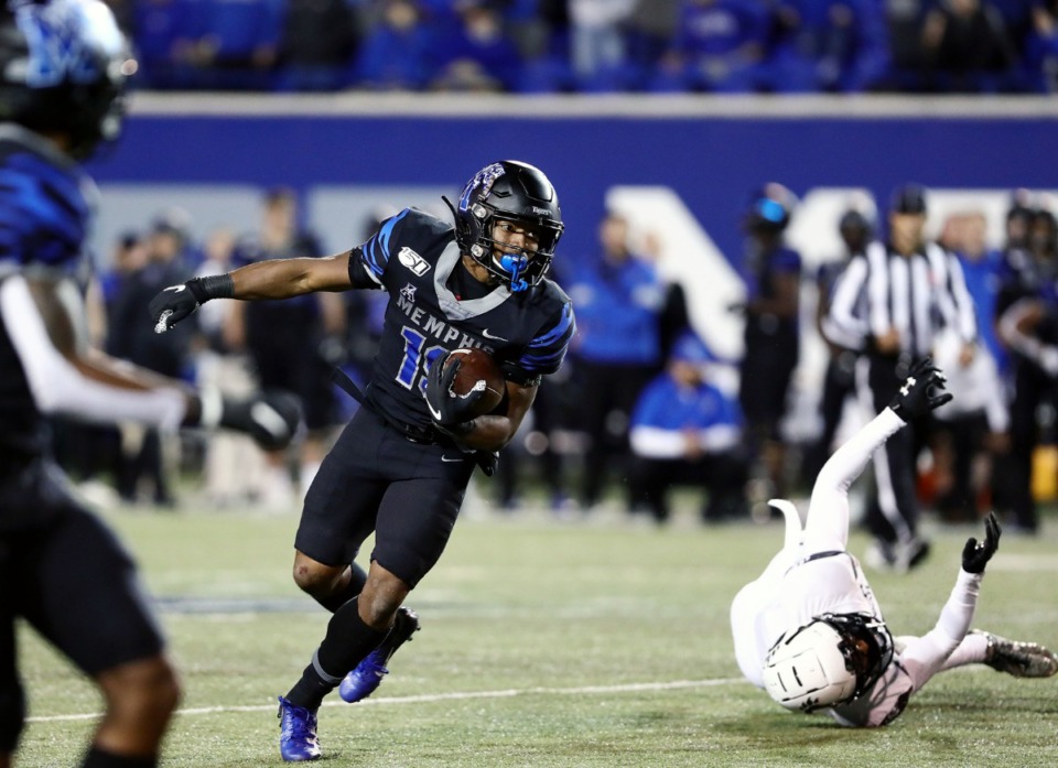 <strong>University of Memphis running back Kenneth Gainwell (19) breaks a tackle during a long fourth quarter run against the University of Cincinnati at the Liberty Bowl Nov. 29.</strong> (Patrick Lantrip/Daily Memphian)