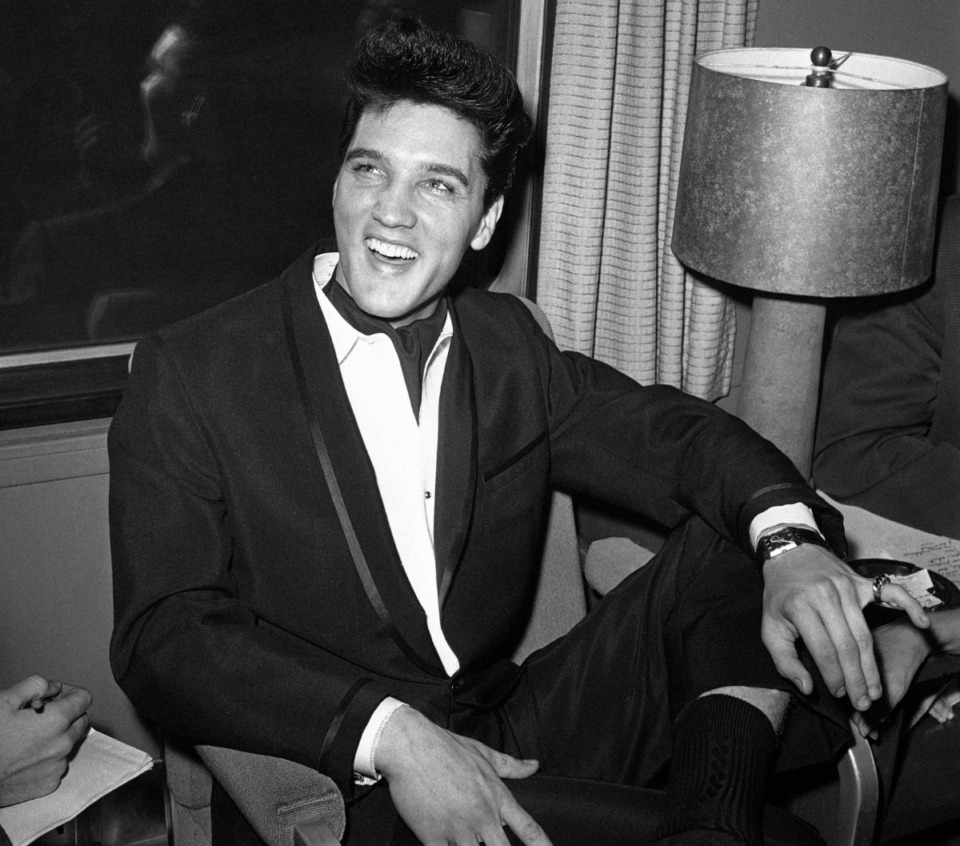 <strong>Influenced by music on both sides of 1950s Memphis' racial divide, Elvis Presley (at a Los Angeles press conference in 1960) became the embodiment of rock and roll.</strong> (HPM/AP)