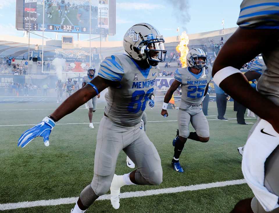 <strong>Tigers tight end Tyce Daniel (left) and wide receiver Tre'Veon Hamilton (right) storm the Liberty Bowl Memorial Stadium prior to the kickoff for the Georgia State game.</strong> (Houston Cofield/Daily Memphian)