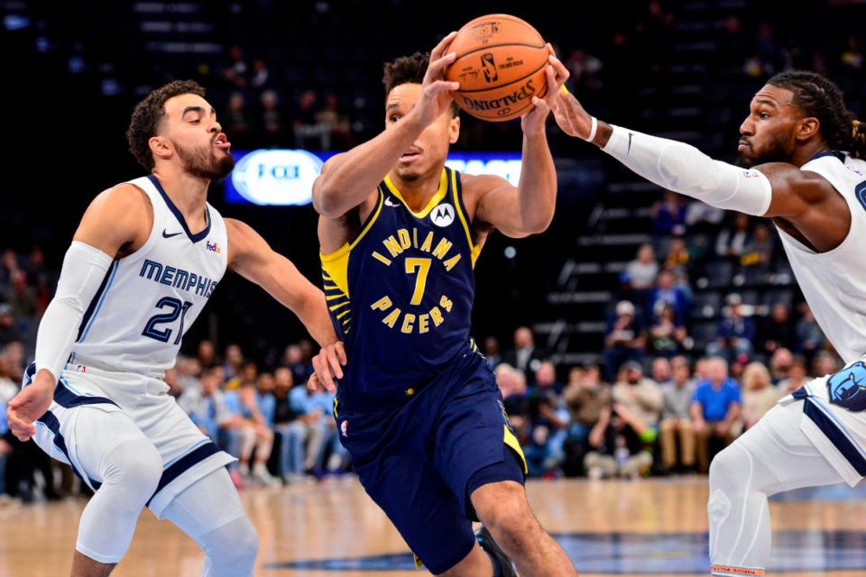 <strong>Indiana Pacers guard Malcolm Brogdon (7) drives between Grizzlies guard Tyus Jones (21) and forward Jae Crowder, right, Dec. 2 at FedExForum.</strong> (Brandon Dill/AP)