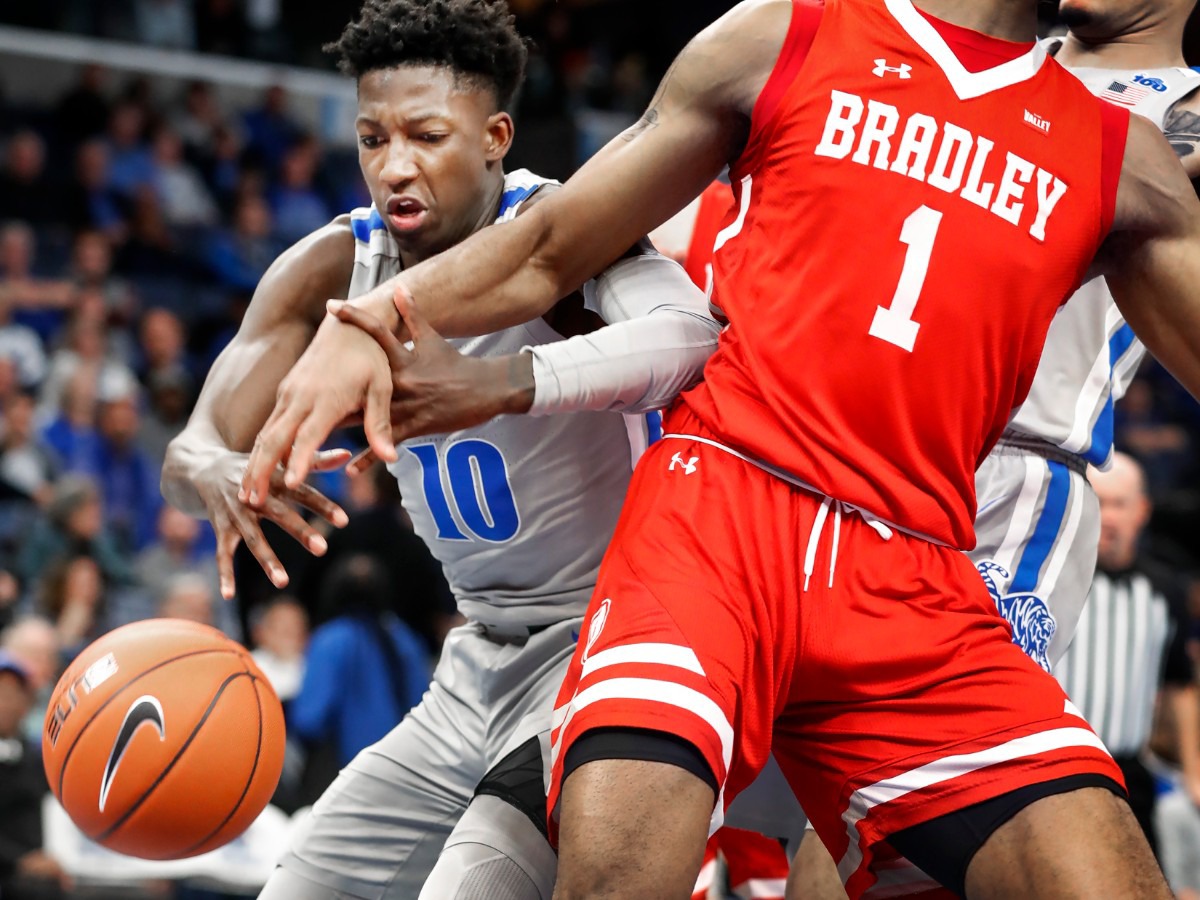 <strong>Memphis Damion Baugh (left) battles for a loose ball during actin against the Bradley defense during action Tuesday, Dec. 3, 2019 at the FedExForum.</strong> (Mark Weber/Daily Memphian)