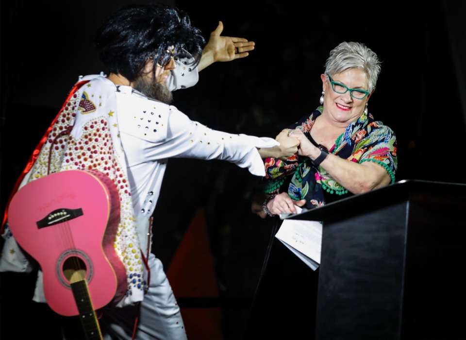 <strong>Dressed as Elvis, Jon Grizzle (left), director of Team BRIDGES, introduces Cynthia Ham, president of BRIDGES, during her retirement party Wednesday, Dec. 4.</strong> (Mark Weber/Daily Memphian)