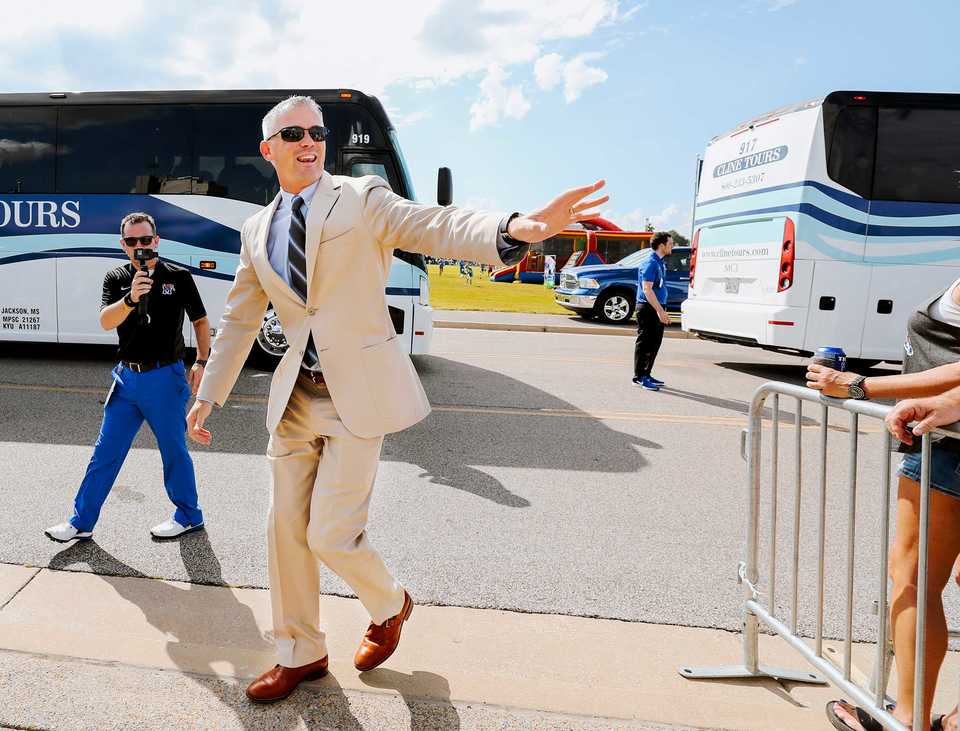 <strong>Tigers football coach Mike Norvell greets fans as he leads his players through Tiger Lane prior to the start of the Georgia State game. Norvell leads his team through a fully programmed game day that includes team meetings, ball drills, stretching and a pre-game meal.&nbsp;</strong>(Houston Cofield/Daily Memphian)