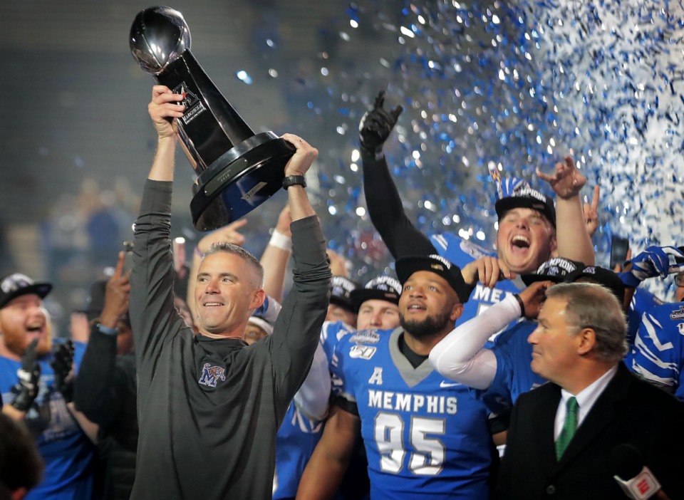 <strong>University of Memphis head coach Mike Norvell (left) celebrates with his team after the Tiger's beat Cincinnati to win the AAC Championship game on Dec. 7, 2019, at the Liberty Bowl Memorial Stadium.</strong> (Jim Weber/Daily Memphian)