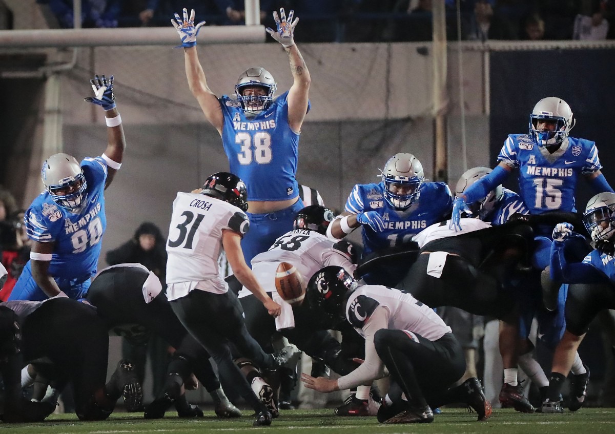 <strong>The University of Memphis defensive line puts pressure on Cincinnati's kicker Sam Crosa during the second half of the Tiger's AAC Championship game on Dec. 7, 2019, against the Bearcats at the Liberty Bowl Memorial Stadium.</strong> (Jim Weber/Daily Memphian)