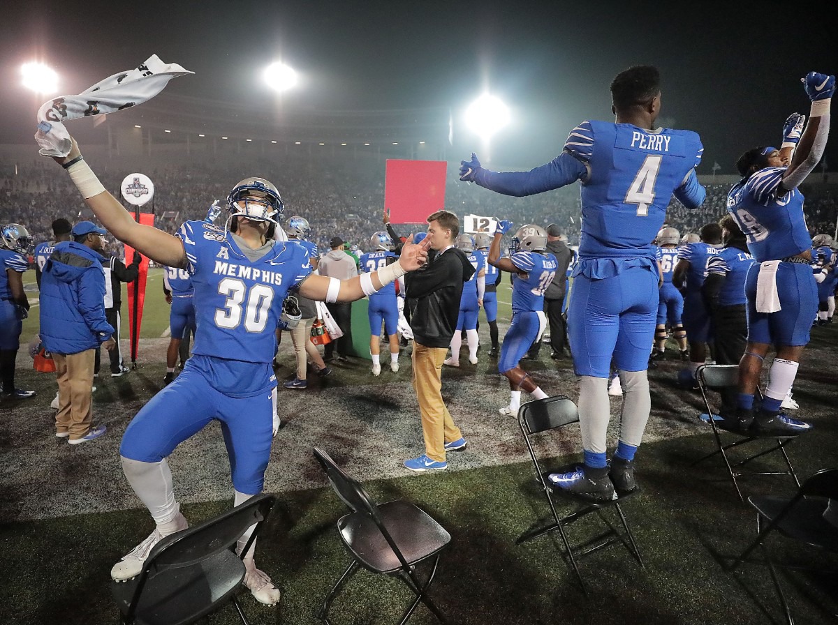 <strong>University of Memphis players celebrate in the final minutes of the Tiger's win over Cincinnati to for the AAC Championship title on Dec. 7, 2019, at the Liberty Bowl Memorial Stadium.</strong> (Jim Weber/Daily Memphian)