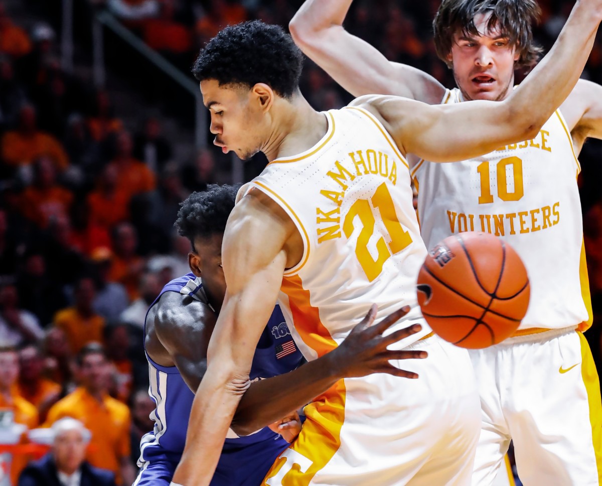 <strong>Memphis guard Damion Baugh (right) makes a no-look pass around Tennessee defender Olivier Nkamhoua (right) during action Saturday, Dec. 14, 2019 in Knoxville, Tennessee.</strong> (Mark Weber/Daily Memphian)