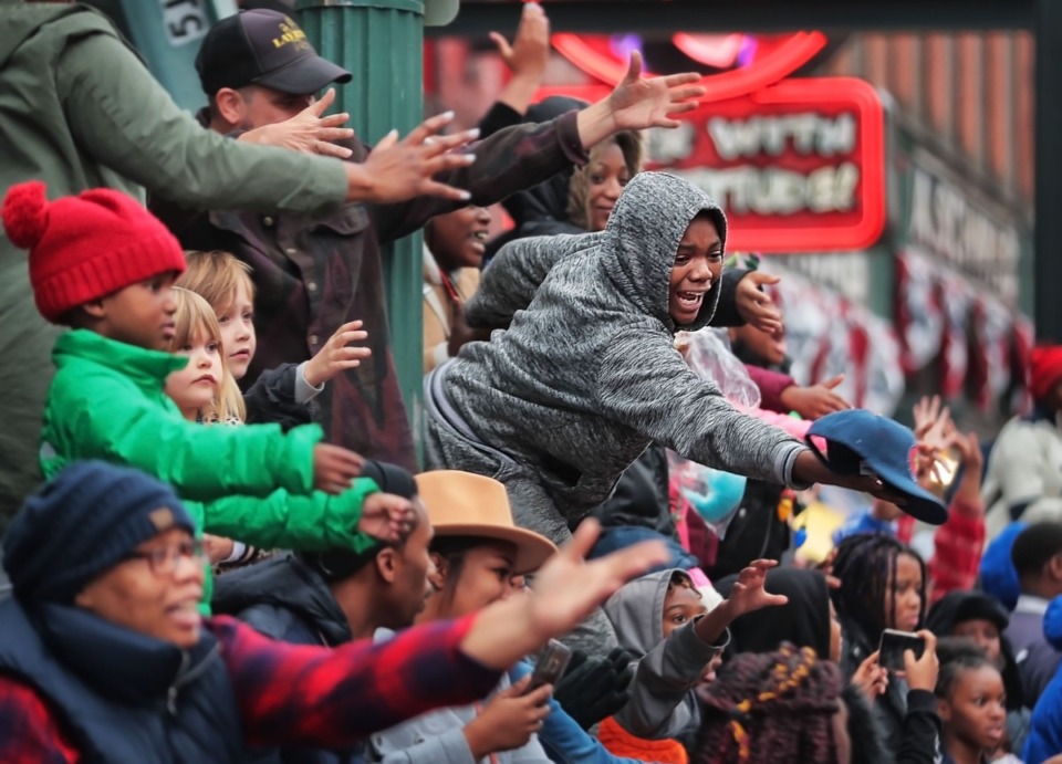 <strong>Paradegoers nab candy, beads and other swag during the 2019 Memphis Holiday Parade on Saturday, Dec. 14. The parade brought thousands to Beale Street to watch dancers, bands, floats, classic cars and Santa usher in the holiday season.</strong> (Jim Weber/Daily Memphian)