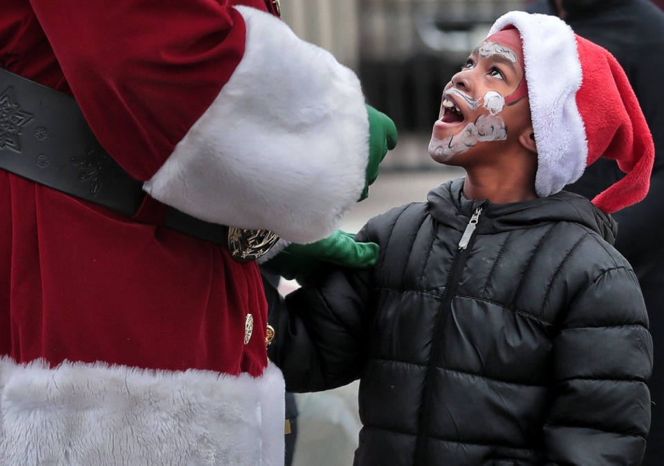<strong>Sporting his own version of the jolly old elf, Brent Williams, 7, gets to meet his idol, played by Stephen Arnold, before the start of the 2019 Memphis Holiday Parade on Dec. 14, 2019. </strong>(Jim Weber/Daily Memphian)