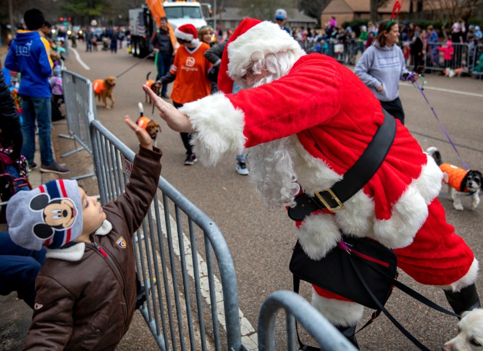 <strong>Cole Jones from Cordova gets a high five from Santa Claus during Germantown's Christmas parade on Dec. 14, 2019.</strong> (Mike Kerr/Special to Daily Memphian)