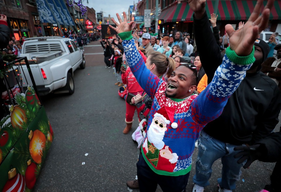 <strong>Dion Chavis gets into the holiday spirit during the 2019 Memphis Holiday Parade on Dec. 14, 2019. The parade brought thousands to Beale Street to watch dancers, bands, floats, classic cars and Santa usher in the holiday season.</strong> (Jim Weber/Daily Memphian)