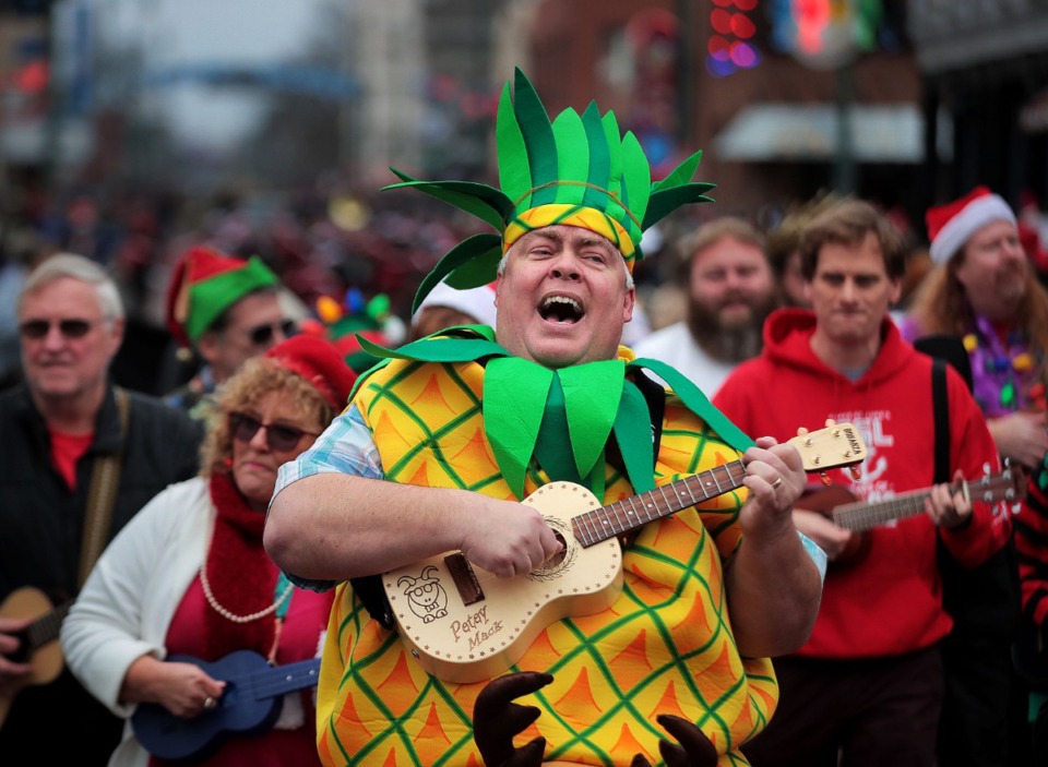 <strong>Pete McCarty leads the Memphis Ukulele Flash Mob during a performance at the 2019 Memphis Holiday Parade on Dec. 14, 2019. The parade brought thousands to Beale Street to watch dancers, bands, floats, classic cars and Santa usher in the holiday season.</strong> (Jim Weber/Daily Memphian)