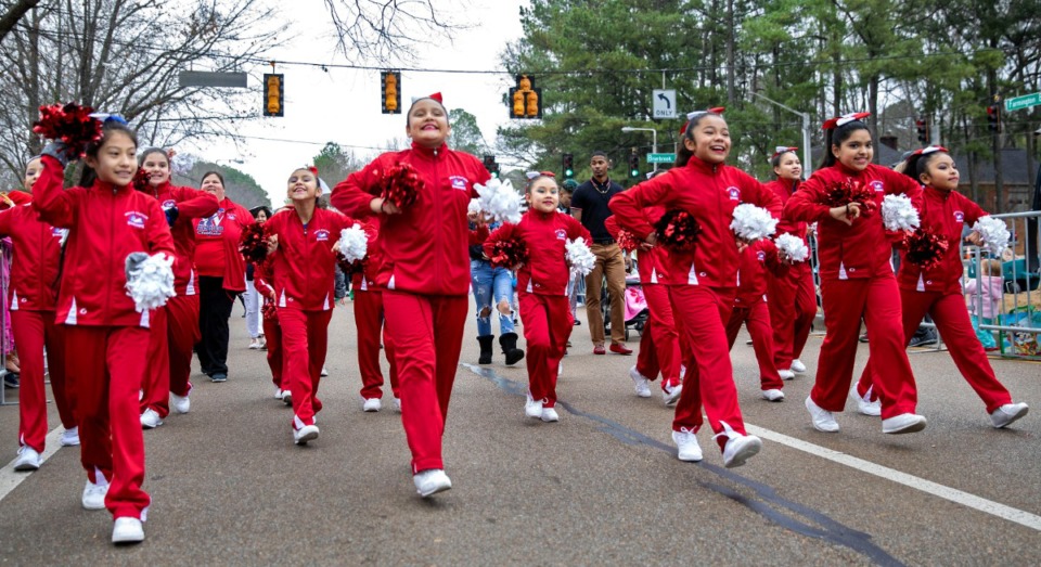 <strong>The Wells Station cheer squad marches along West Farmington during the Germantown Christmas parade on Dec. 14, 2019.</strong> (Mike Kerr/Special to Daily Memphian)