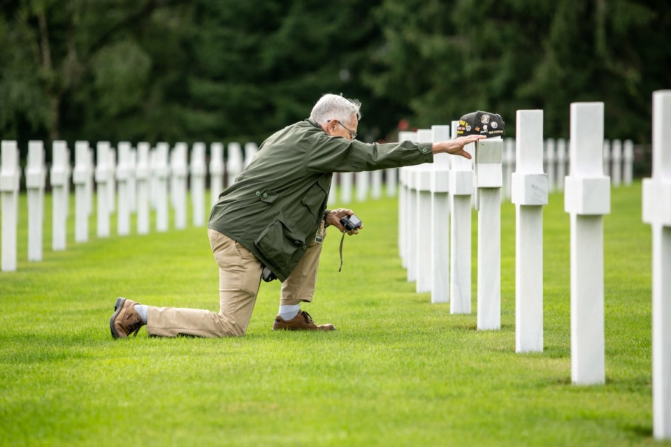 <strong>Merrill Phillips pays his respects at Henri-Chappelle Cemetery near the village of Henri-Chappelle, Belgium. Nearly 8,000 Americans are buried there. Most were killed in the Battle of the Bulge. Dec. 16, 2019 marks the 75th anniversary of the Battle of the Bulge.</strong> (Zach Coco/Forever Young)