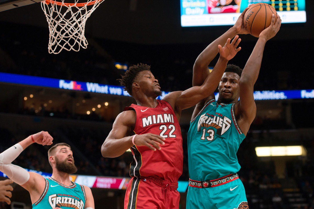 <strong>Grizzlies forward Jaren Jackson Jr. (13) grabs a rebound against Miami Heat forward Jimmy Butler (22) Dec. 16 at FedExForum.</strong> (Brandon Dill/AP)