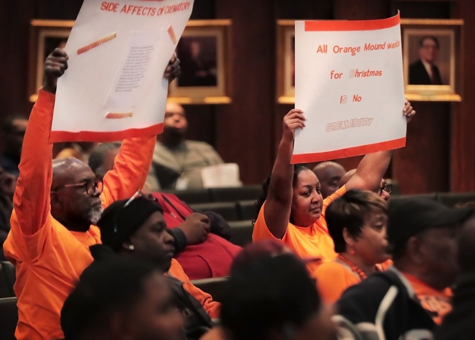 <strong>Orange Mound residents Thomas Greer (left) and Paula Campbell protest during a Board of Adjustment meeting at City Hall on Dec. 18, 2019, where the board ruled against Anastasia Davis who was seeking a variance that would allow her to build a crematorium on Park Avenue in Orange Mound.</strong> (Jim Weber/Daily Memphian)