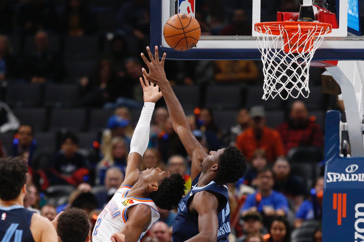 <strong>Oklahoma City Thunder guard Shai Gilgeous-Alexander, left, shoots in front of Memphis Grizzlies forward Jaren Jackson Jr., right, Dec. 18 in Oklahoma City.</strong> (Sue Ogrocki/AP)