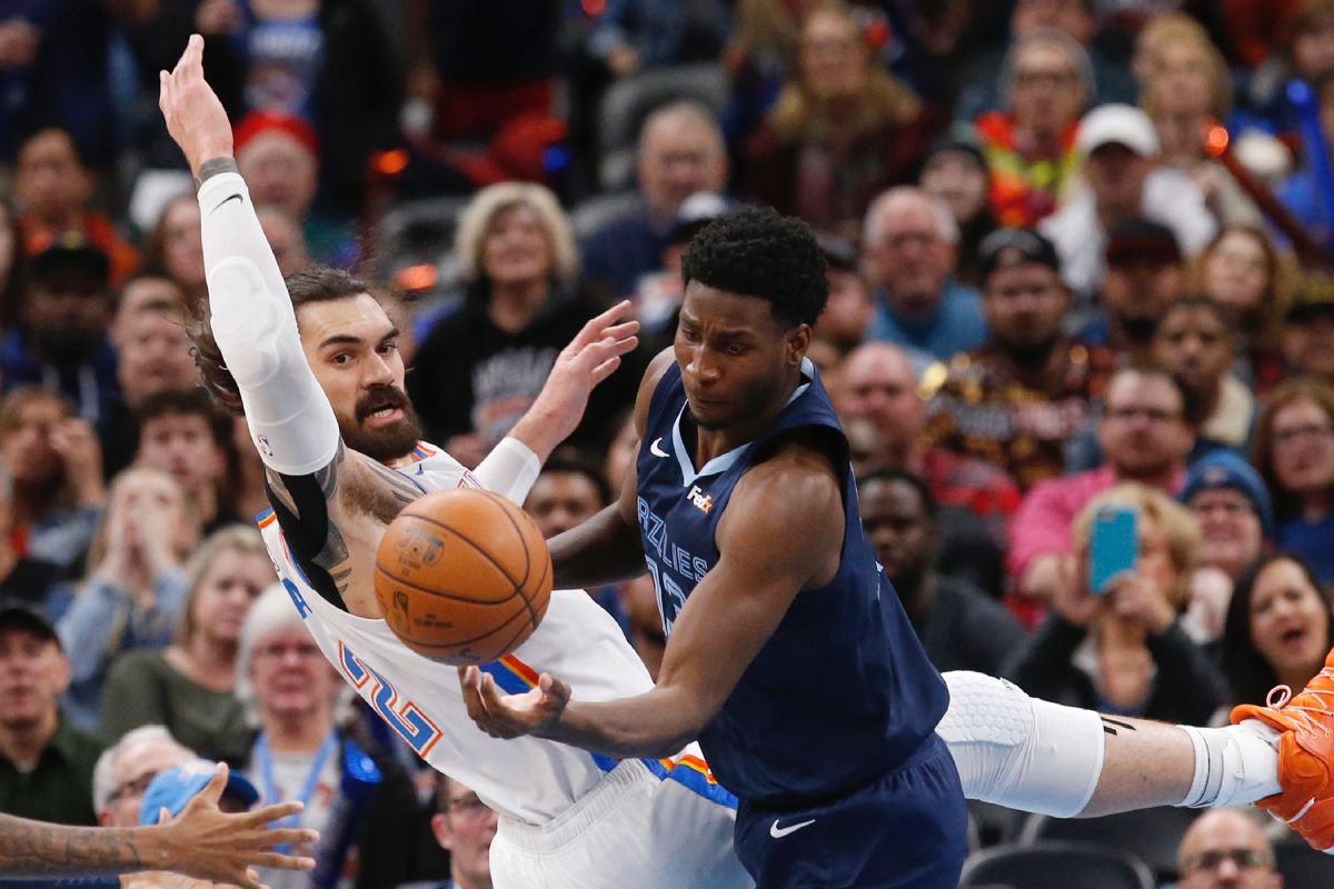 <strong>Grizzlies forward Jaren Jackson Jr., right, grabs a rebound in front of Oklahoma City Thunder center Steven Adams, left, Dec. 18 in Oklahoma City.</strong> (Sue Ogrocki/AP)