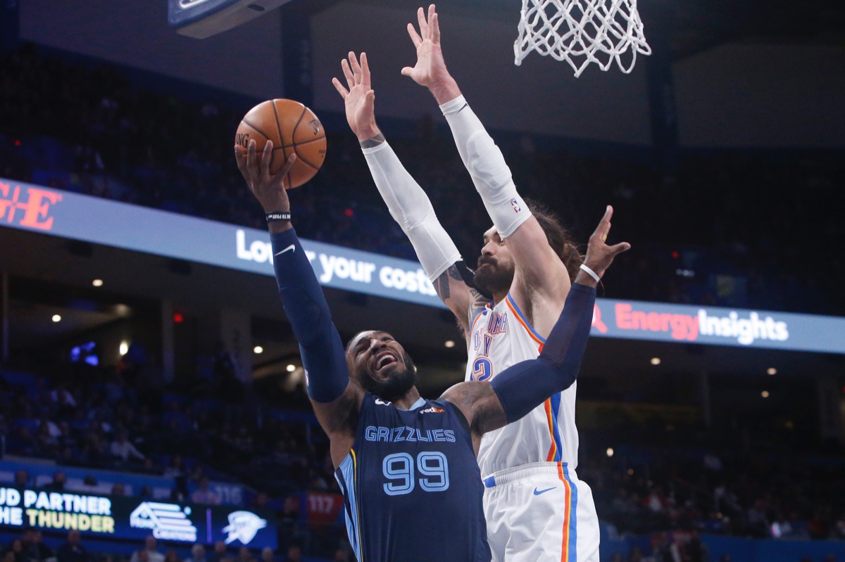 <strong>Grizzlies forward Jae Crowder (99) shoots as Oklahoma City Thunder center Steven Adams (12) defends Dec. 18 in Oklahoma City.</strong> (Sue Ogrocki/AP)